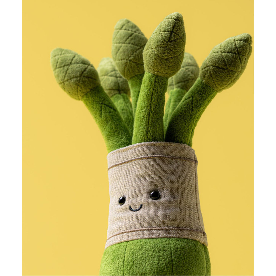 Maskotka Jellycat Amuseables – Szparagi 22 cm, zbliżenie na buzię i lnianą opaskę